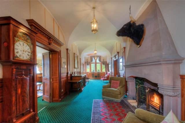 The grand hall has a an original marble chimney piece and canopy.