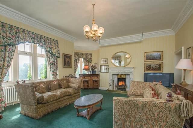The formal living room has traditional furniture and a feature marble fireplace.