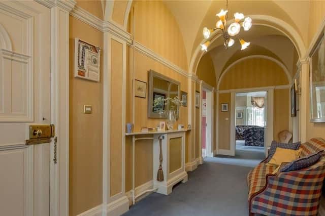 The hallway has an arched ceiling.
