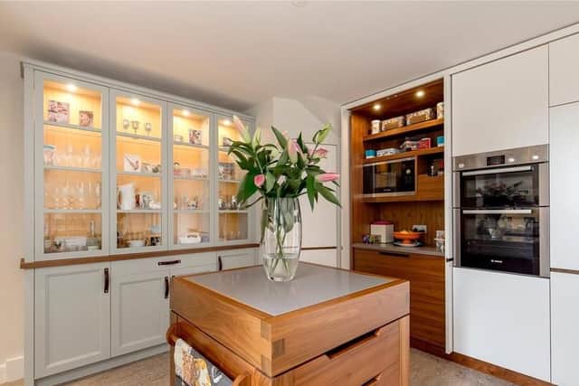 The kitchen is fully equipped with lots of different types of storage.