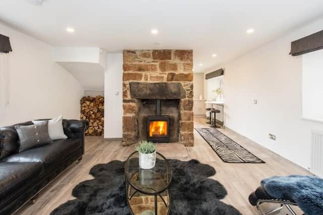 The cosy living room has a wood burning stove/