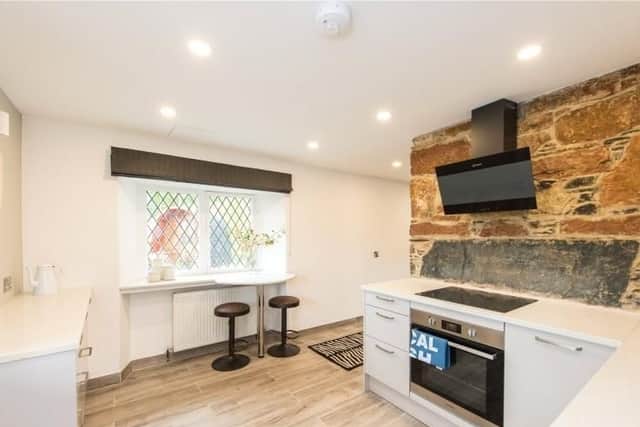 The kitchen also has a small dining area by the window.