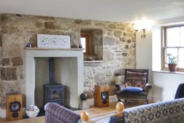 The cosy living room has a wood burning stove.