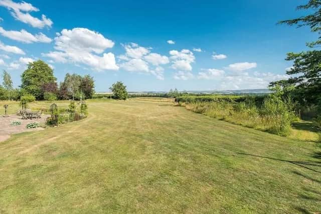 The house sits in landscaped gardens,
