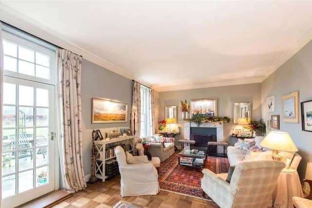 The cosy family room with feature fireplace.