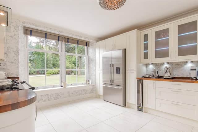 The spacious, modern kitchen has views of the garden.