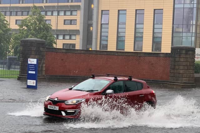 Cars were forced to drive through deep puddles following flash flooding.