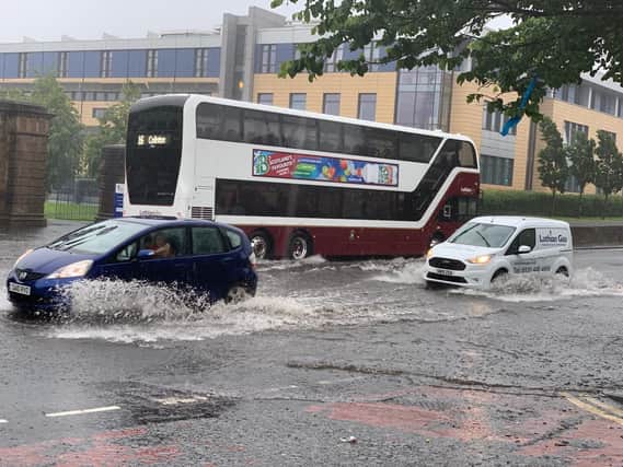 Traffic battles with the flood water in Edinburgh (Photo: TSPL)