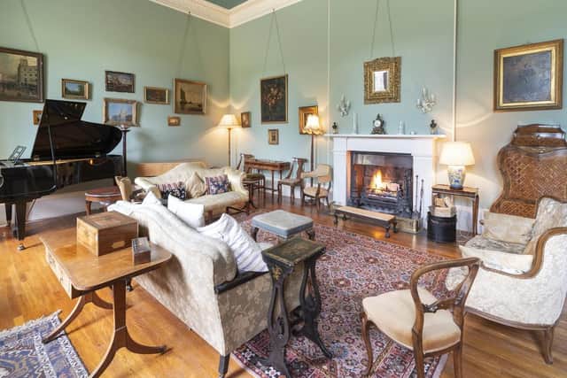 The spacious drawing room has a traditional fireplace.