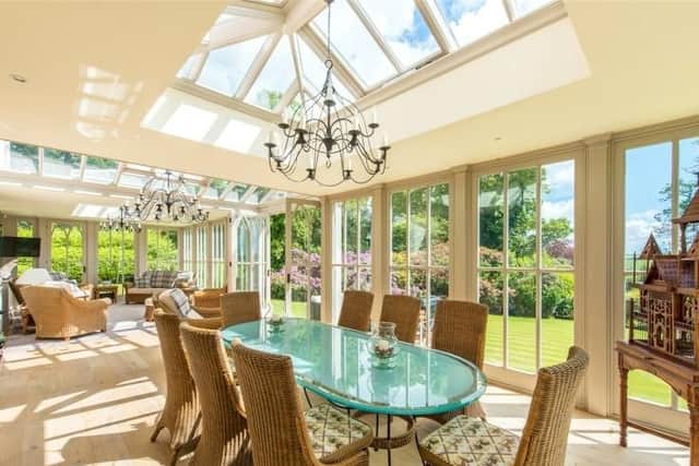 The garden room is an ideal spot on a sunny day, and has a sitting and dining area.