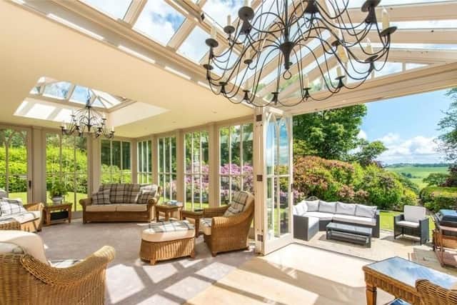 The living room area of the garden room opens out to the patio.