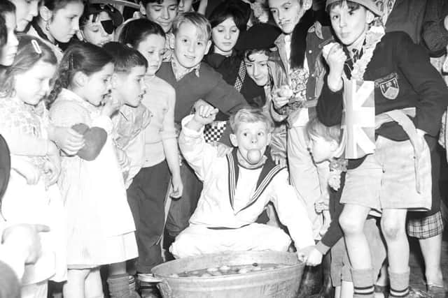 Halloween parties were spent dooking for apples.