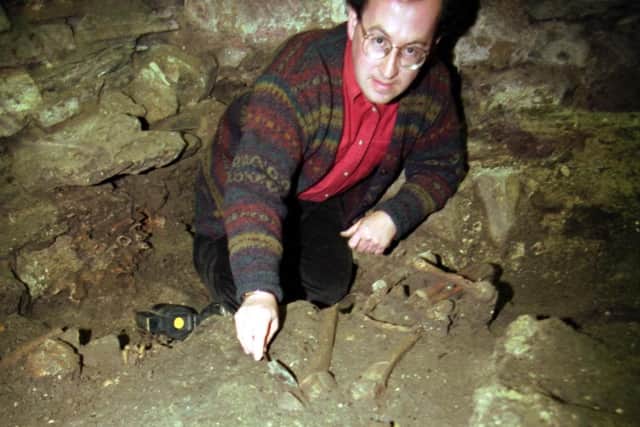 Edinburgh District Council archaeologist Mark Collard with one of the seventeen 16th century skeletons discovered under Magdalen chapel in the Cowgate in July 1992.