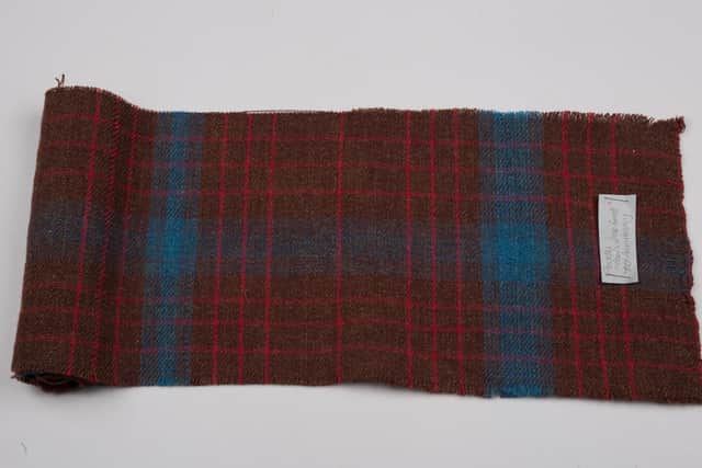 Sample of Flodden Floors of the Forest 700th Anniversary tartan, made by Christine Macleod, former property manager and handloom weaver at Weavers Cottage at Kilbarchan.