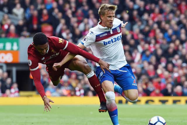 Mauritz Bauer holds off Liverpool defender Joe Gomez during an English Premier League clash