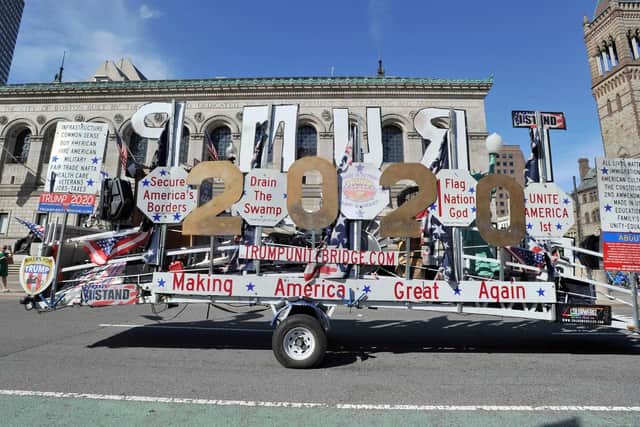 A float dedicated to re-electing President Donald Trump rides by the Boston Public Library.