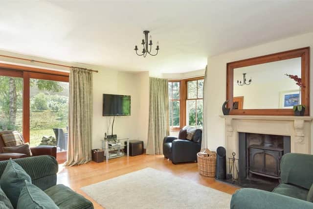 The cosy living room has a wood burning stove and garden access.