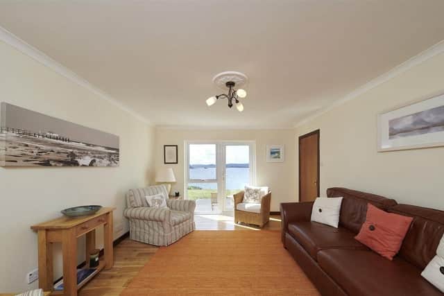 The living room has new oak flooring and a neutral colour scheme.