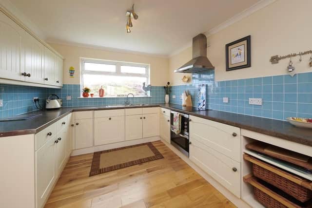 The colourful kitchen also has views out to the loch and beyond.