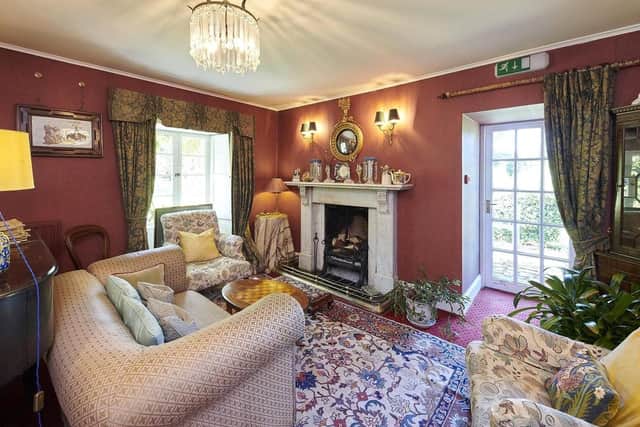 The drawing room has garden access and a feature fireplace.