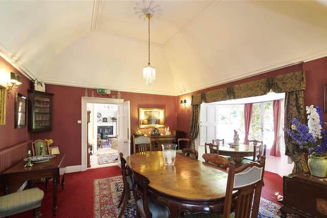 The dining room also has bay windows and doors opening to sheltered terraces in the garden.