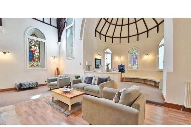 The living space has stained glass windows, ceilings nine metres up and an impressive circular nave.