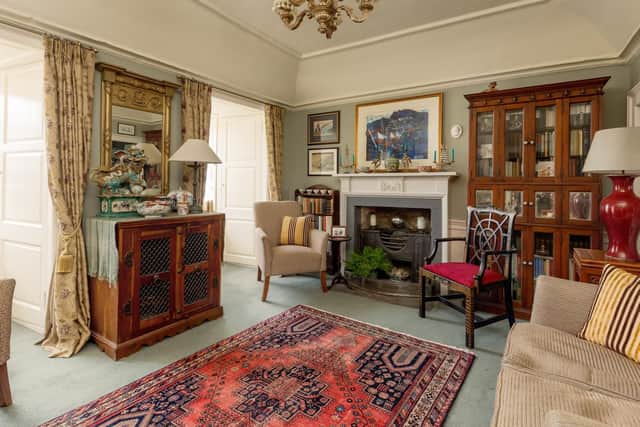 The living room has some original features and has been decorated to reflect the era of the home.