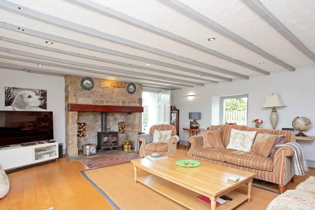 The 27ft living room features original ceiling beams