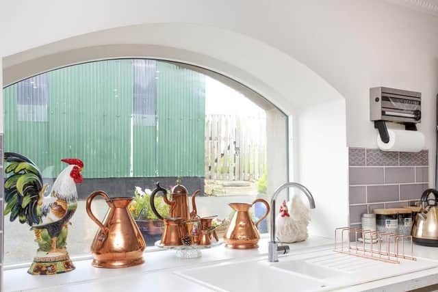 As well as the original fireplace in the living room, the kitchen has a traditionally shaped window from when the house was a blacksmiths.