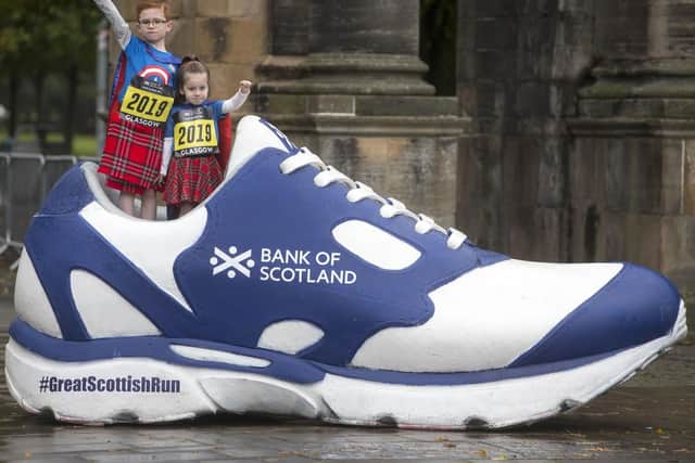The Shaw family from Cumbernauld, who have raised funds for local charities each year, were out in their kilts once again to cross the finish line of the Bank of Scotland Great Scottish Run Family Mile. Picture: Jeff Holmes