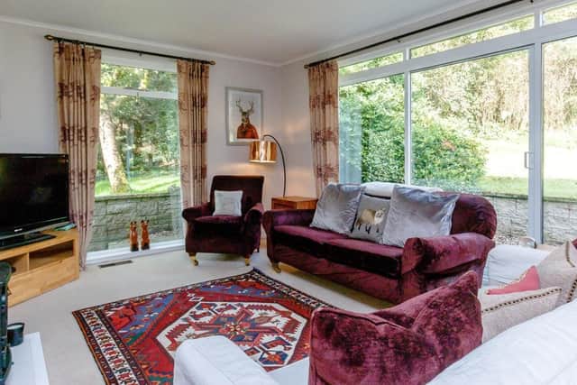 The cosy sitting room has sliding doors to the garden.