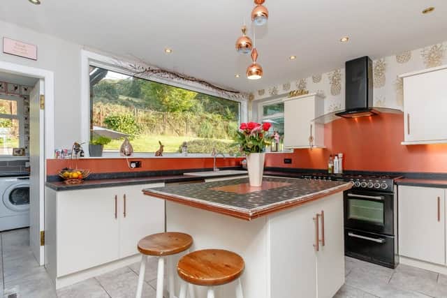 The kitchen has a range cooker and views of the garden.