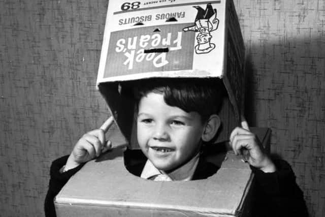 Little Michael Haughian of Clermiston, Edinburgh, gets to work on his robot costume for Halloween 1951.