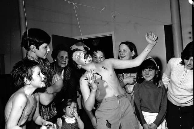 A traditional game on a Scottish Halloween - catching the treacle scone at a children's Halloween party at Greenside Parish Church in Edinburgh, 1971.