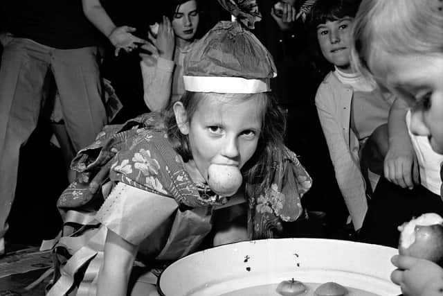 Elizabeth Watson dooking for apples in November 1971 at the children's Halloween party at Greenside Parish Church in Edinburgh.
