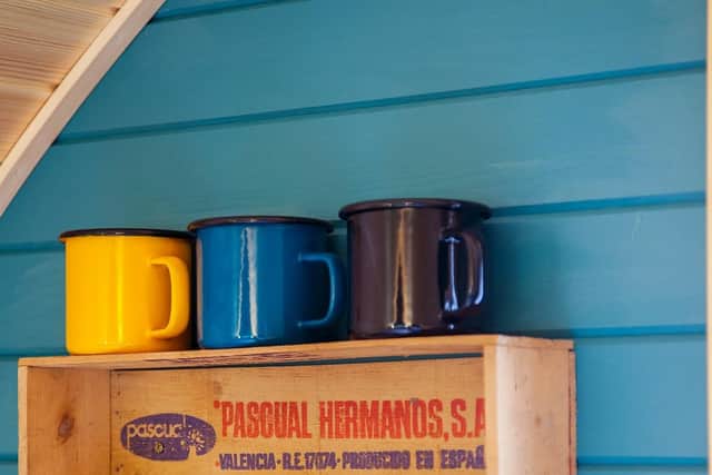 There's cutlery, mugs, plates and bowls in the kitchen area all neatly stowed away or stylishly displayed.