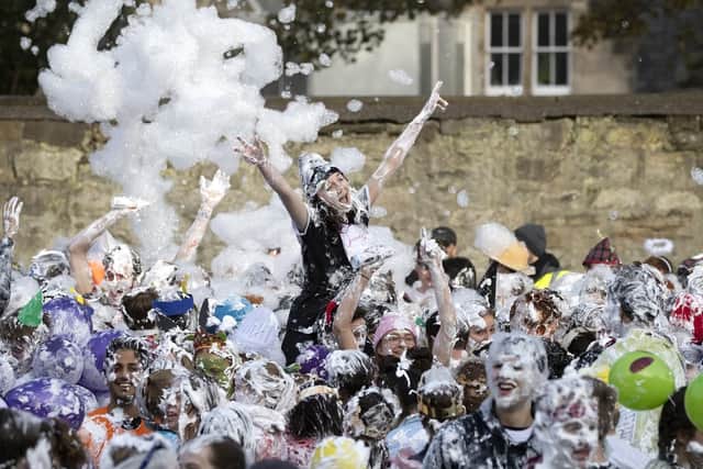 The so-called "children" are given embarrassing costumes to wear and take part in a shaving foam fight in St Salvator's Quad in the Fife town.