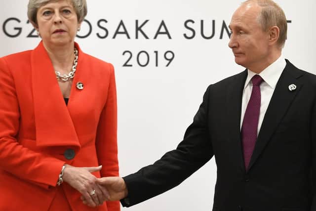 Former prime minister Theresa May shakes hands with Russian president Vladimir Putin earlier this year