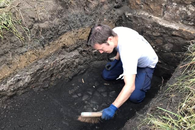 Members of the 1722 Waggonway Heritage Group uncovered the cobbled surface
of Scotland's first railway track in East Lothian. PIC: Ed Bethune.