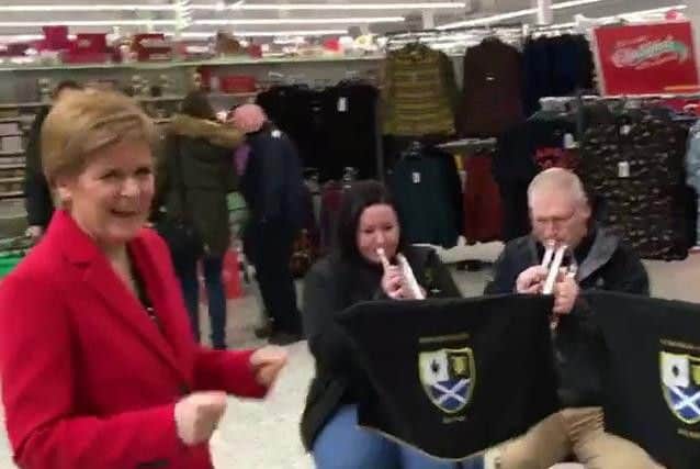 Dressed in festive red, the SNP leader hopped up and down on the spot as the band played the festive tune.