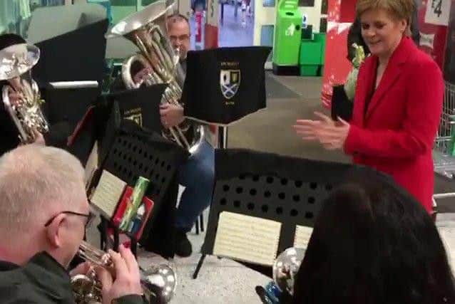 Musicians said Scotland's First Minister was in the supermarket with her husband when she spotted the troupe and stopped to praise their talents.