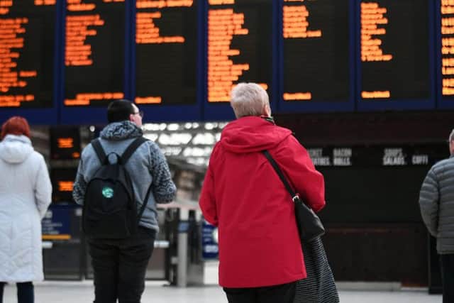 ScotRail passengers look for their next service on the main board at Glasgow Central station