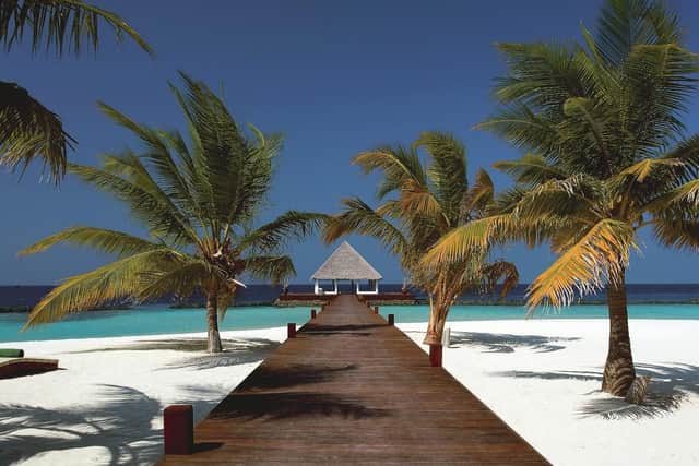 White sands, turquoise sean and palm trees, the classic Maldives resort view