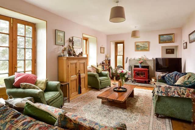 The cosy living room has a wood burning stove.