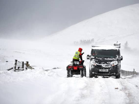 Vehicles struggle through snow on the B797 between Leadhills and Wanlockhead.