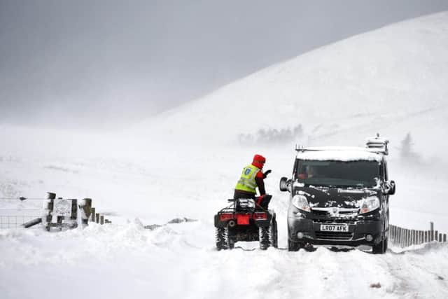 Vehicles struggle through snow on the B797 between Leadhills and Wanlockhead.