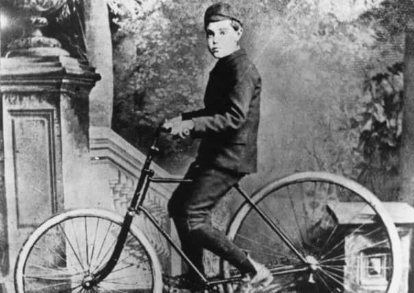 John Dunlop's son, on the first bicycle to have pneumatic tyres. Picture: Getty