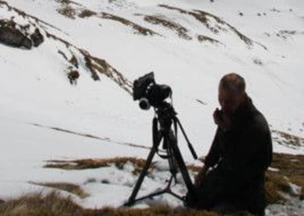 Award-winning filmmaker Matt Brown lining up a gully shot on the south-east face of Meall Corranaich