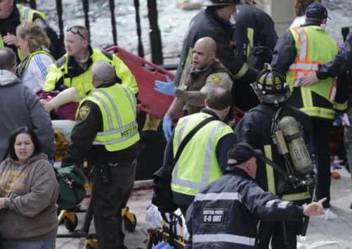 Medical workers aid injured people at the finish line of the 2013 Boston Marathon following an explosion. Picture: AP