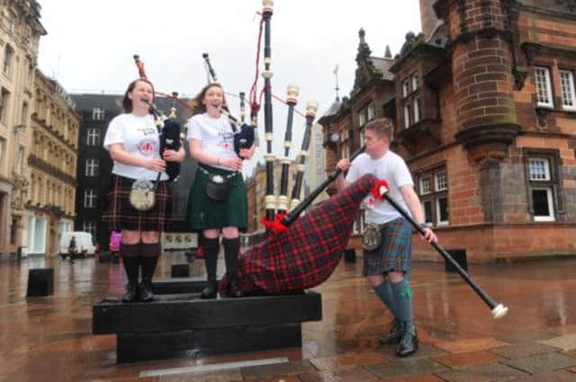 Rebecca Tierney, 16, Robyn McKay, 15 and Harry Richards, 15, celebrate the tenth year of Piping Live! Picture: Robert Perry